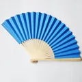 Detailed view of 23cm blue folding paper fan with natural bamboo ribs on white background. - 23cm / Sapphire Blue