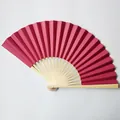 Detail view of high-quality 23cm dark pink paper folding fan with natural bamboo ribs - 23cm / Burgundy