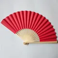 Detailed view of a vibrant red paper folding fan with natural bamboo ribs - 23cm / Red