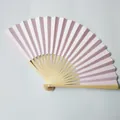 Detailed macro view of a 23cm light pink paper folding fan featuring premium bamboo ribs - 23cm / Pink
