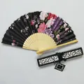 Detail of a Japanese style floral silk folding fan with a decorative hollow gift box. - Black Peony (IFANS) / Black Gift Box