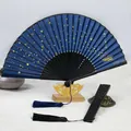 Traditional Chinese starry sky folding fan with gold stamping and elegant silk tassels - Galaxy Blue