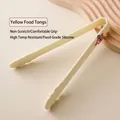 Creamy yellow food-grade silicone cooking tongs with cute cartoon bear decoration - Creamy Yellow Cartoon Food Tongs