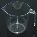Clear plastic measuring cup with handle and visible dual-scale markings for baking - 600ml
