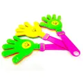 Detailed view of large colorful plastic hand clappers with smiley faces for party cheering. - Triple Layer Large Hand Clapper (Random Color)