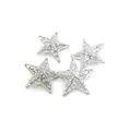 Detailed view of four silver hollow filigree star ornaments for Christmas trees - 8cm 4 Pieces/Pack / Bright Silver