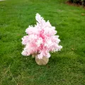 A beautiful mini pink flocked Christmas tree with a burlap base displayed on green grass - Flocked Pink / 30cm / Pink