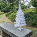 Detailed view of a small white Christmas tree displayed on a garden stone bench. - No Light Style / 45cm