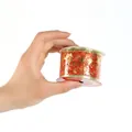 Primo piano di un nastro natalizio rosso con stelle dorate stampate su un rotolo. - Modello casuale / tonalità rosse