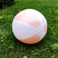 Macro view of a 36cm pink and white inflatable beach ball resting on a green lawn - Light Pink White
