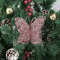 Glittery pink butterfly ornament hanging on a festive Christmas tree decoration - Rose Gold 12-pack / 7cm
