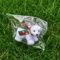 Close-up of a white plush polar bear Christmas ornament with a red and green plaid scarf - Multicolor Scarf