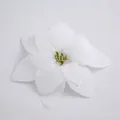 Detail view of a white artificial poinsettia flower used for Christmas tree decorations - White
