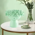 Close-up of a light green Nordic creative face-shaped succulent planter on a table. - Mint Green