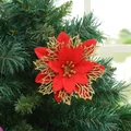 Detailed close-up of a red and gold artificial poinsettia flower for Christmas tree decor - Red + Gold