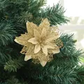 Close-up of a sparkling gold artificial poinsettia flower decoration on a Christmas tree - Gold