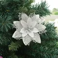 Macro detail of a silver glitter poinsettia flower ornament on a green Christmas tree - Silver