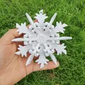 Macro view of a 12cm white glittery 3D snowflake Christmas tree ornament. - Style B / White