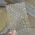 Detail showing golden feather nail art stickers with delicate crystal rhinestones - New Gold Feather Crystal (TO6080) / Gold