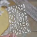 Detailed view of white feather nail art stickers with delicate rhinestones and cursive text - White Feather Crystal (TO6081) / White