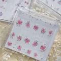 Macro view of pink blush nail stickers with stars and rhinestones in clear case. - MD039 (Pink Arc Mix Rhinestone Style)