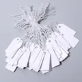 Blank white paper hang tags with strings, ideal for jewelry price labels and craft marking. - Size Approx. 13*26mm / 100 Pieces/Pack / White
