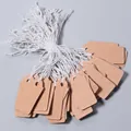 Detail view of blank brown kraft paper price tags with white strings for jewelry retail display. - Size Approx. 13*26mm / 100 Pieces/Pack / Kraft Color