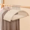 Flocked clothes hanger variant in beige, non-slip design, perfect for home wardrobe storage. - Oval / Pink