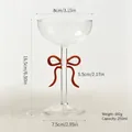 Elegant glass wine goblet with a creative red bow tie on the stem, 250ml capacity. - Cocktail Glass / Red