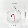 Transparent glass Christmas ornament ball featuring an internal red candy cane, 8cm wide - Candy