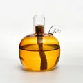 Elegant modern spherical glass oil lamp with amber liquid and clear glass wick cover - Champagne