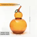 Tarro de cristal ámbar en forma de calabaza con tapa de hoja verde - Champaña Transparente