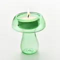 Portacandele decorativo in vetro verde a forma di fungo con candela tealight accesa - Verde
