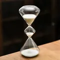 Elegant three-tier glass hourglass sand timer with white sand on a wooden desk surface - Triple Layered Conical / Non-timing (8x19cm) / White