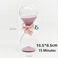 Elegant 15-minute glass sand timer featuring pink sand and dried floral decoration - 15 Min With Flowers - Light Pink Sand