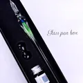 Detailed macro shot of an elegant handmade glass dip pen set inside its black gift box. - Water Haze / Small Gift Box Set