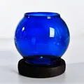Cobalt blue round glass candle holder with dark wooden base variant display. - Round Style / Blue
