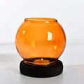 Elegant amber round glass candle holder with dark wooden base for warm tea light ambiance - Round Style / Champagne