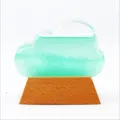 Minimalist cloud-shaped storm glass weather predictor with green liquid and wooden base - Green
