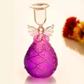 Detailed view of a purple glass angel candle holder with glitter and pearls decoration. - Purple Angel Style
