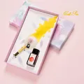 Elegant yellow quill pen set with glass dip pen and red ink in a stylish gift box. - Phoenix Feather Yellow