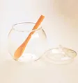 Detail of round clear borosilicate glass sugar jar with lid and orange serving spoon - Smooth Style (TG002)