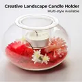 Clear glass tealight holder with internal red sand and artificial flower landscape design - S