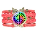 Red handmade braided bracelet featuring rainbow peace symbol and bronze butterfly charm - Red