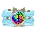 Multilayered light blue braided leather bracelet featuring a rainbow peace sign cabochon charm - Light Blue