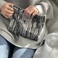 Close-up detail of black and white textured fabric pouch, elegant vintage style clutch bag. - Black & White Stripes