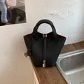 Stylish black leather bucket bag for women, classic design handbag with top handle and lock. - No Pendant / Black