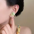 Handmade green and pink floral beaded earrings worn by a model for a soft feminine style - Green (E6960)