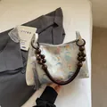 New Chinese style shoulder bag featuring elephant prints and wooden bead strap detail - Elephant Print Style / Blue