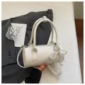 Detailed view of a white barrel handbag featuring a pearl bow and lace charm - White (With Pearl Lace Pendant) / White